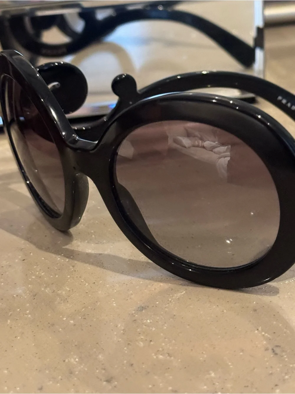 Prada Black Round Sunglasses with Swirl Arms